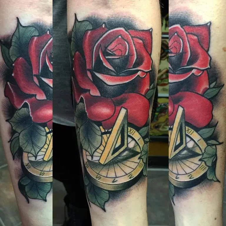 A tattoo of a rose with a compass, perfect for touch ups.