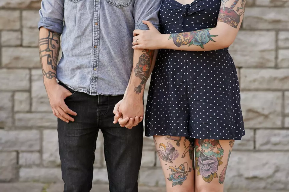 Man, woman, tattoos.