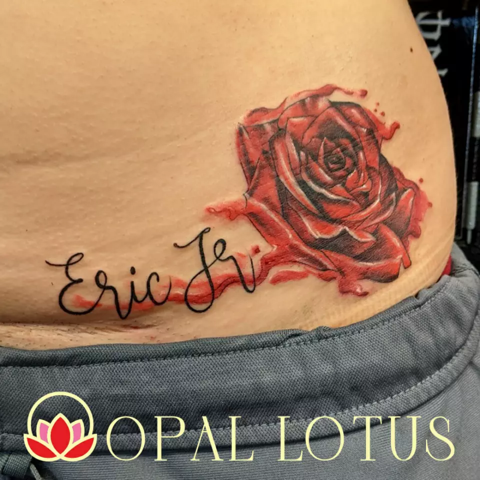 A red rose tattoo featuring the name Eric F. available in the Houston Katy Area.