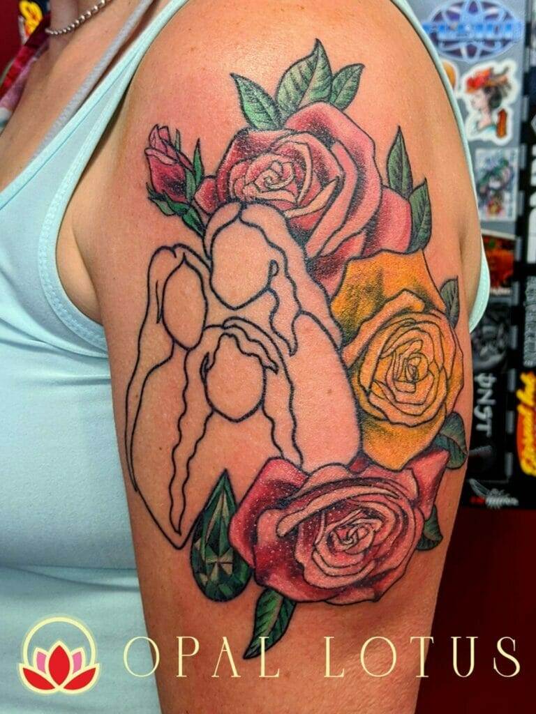 A Houston tattoo of a woman with opal lotus roses on her arm.