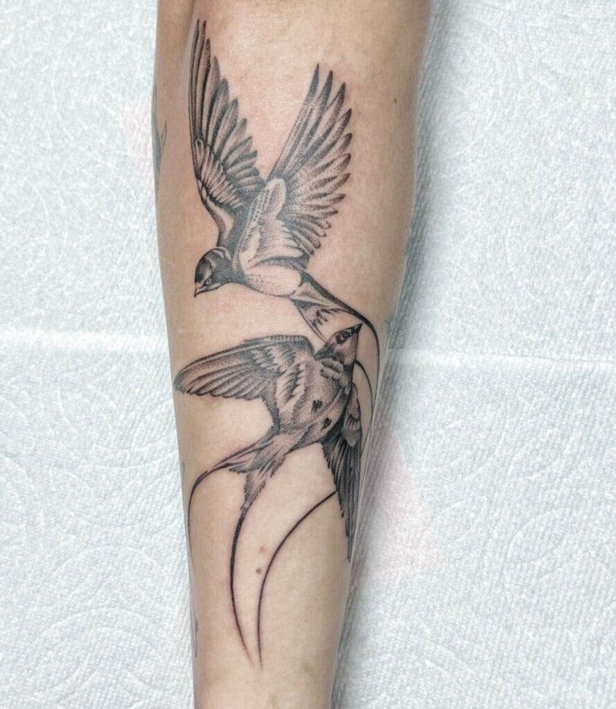 Swallow tattoos on forearm.